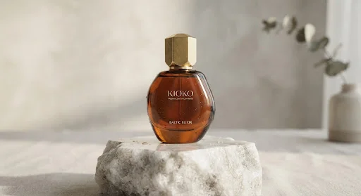 KIOKO skincare bottle on a sculptural stone pedestal